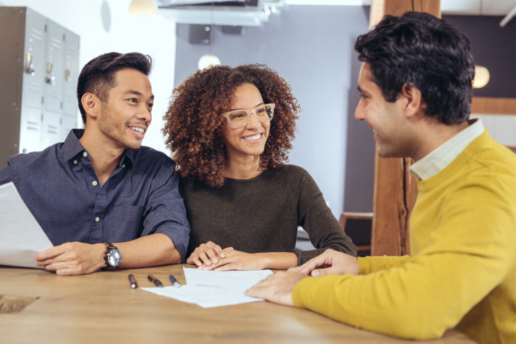 Young couple interviews a prospective real estate agent