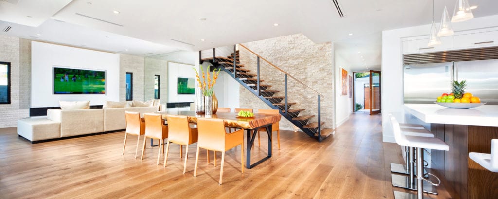 Open plan living area with hardwood floor in two-story home