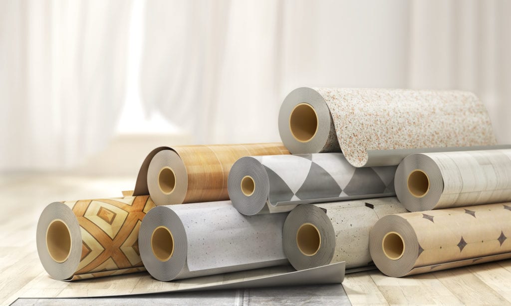 Rolls of linoleum with different patterns and textures
