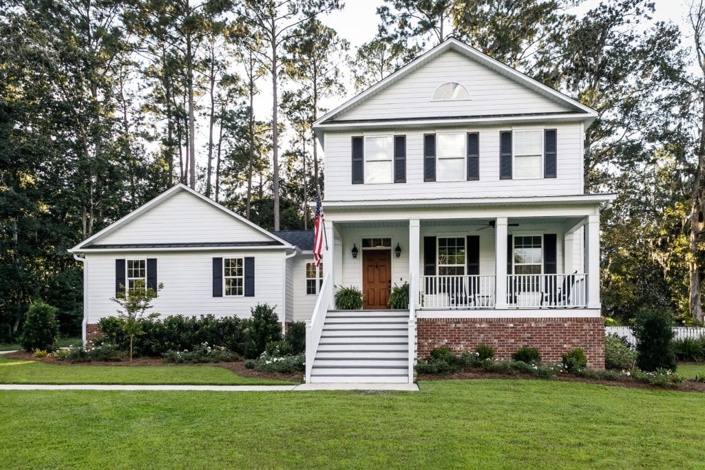 Suburban White Contemporary Farmhouse with American flag