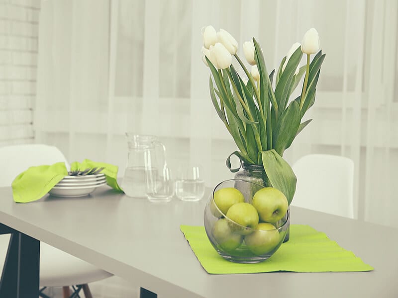 Kitchen table with green apples and decor 