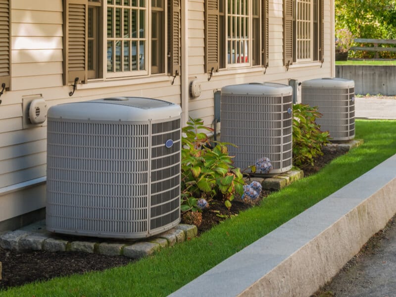 Row of HVAC units outside of homes