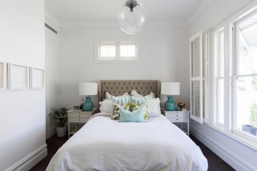 White bedroom with blue accents small space mistakes