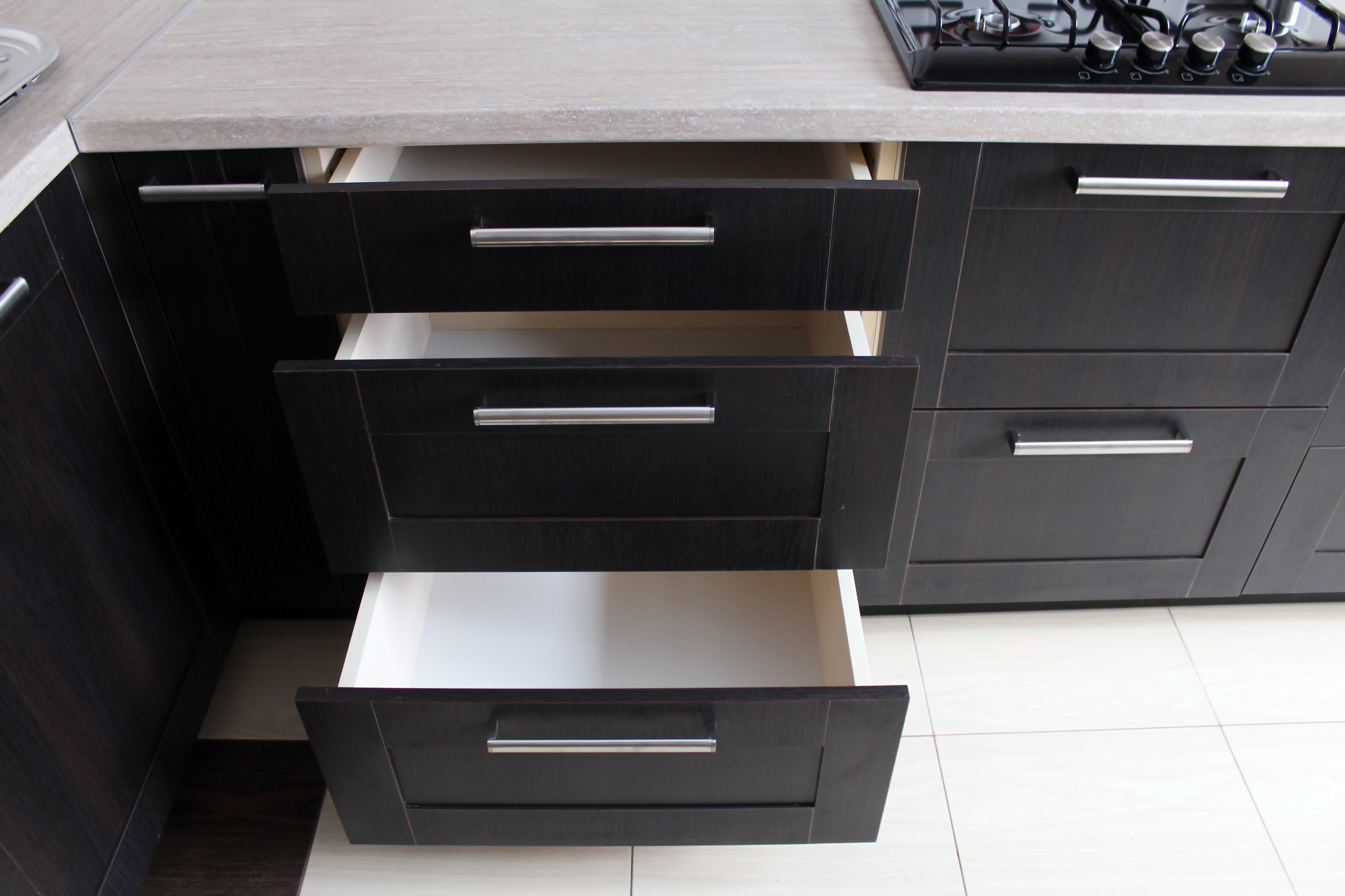 Black kitchen cabinets with open drawer