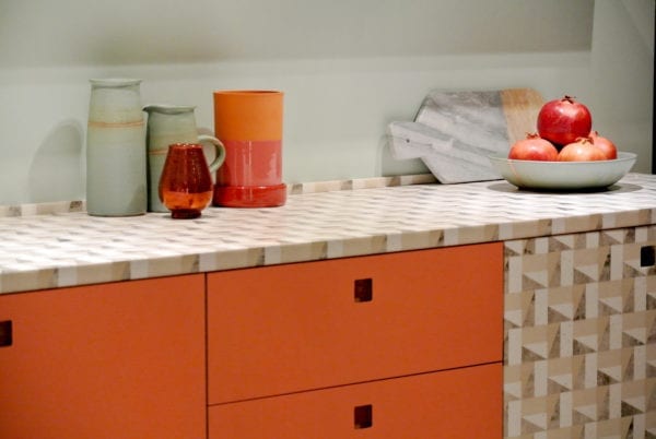 Kitchen counter with patterned top and orange cabinets