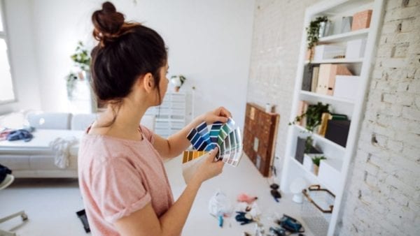 Woman choose paint color for shelves