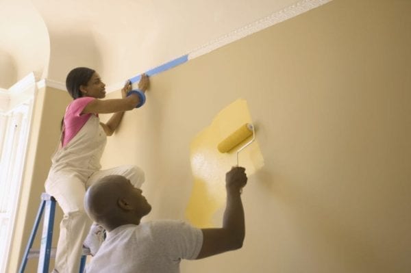 Couple Painting Wall Yellow