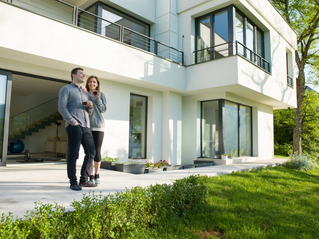 couple in front of modern home