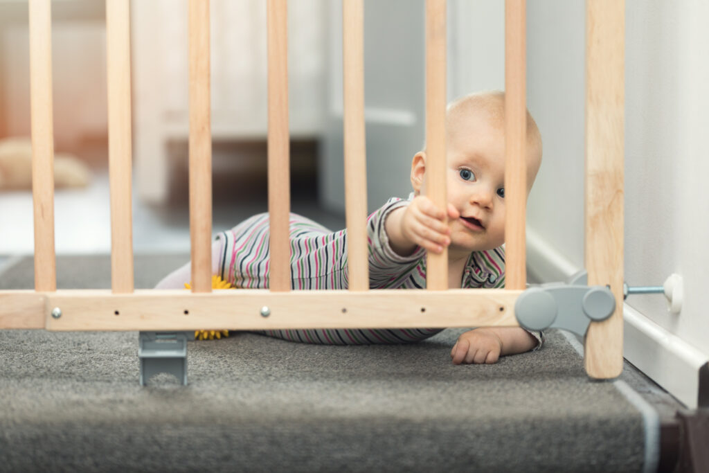 child behind baby gate