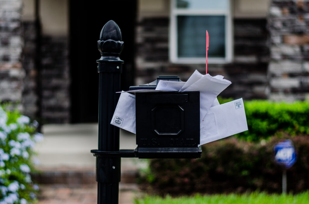 overflow mailbox with house in background