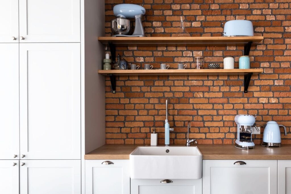 Modern industrial kitchen with brick backsplash
