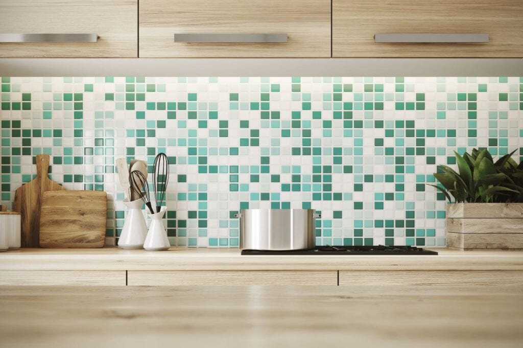 Close up of kitchen counters with green and white tile backspash