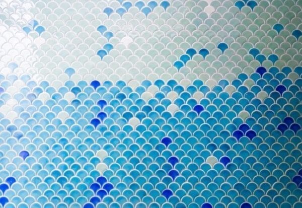 Blue tiles in fish-scale pattern for coastal kitchen backsplash