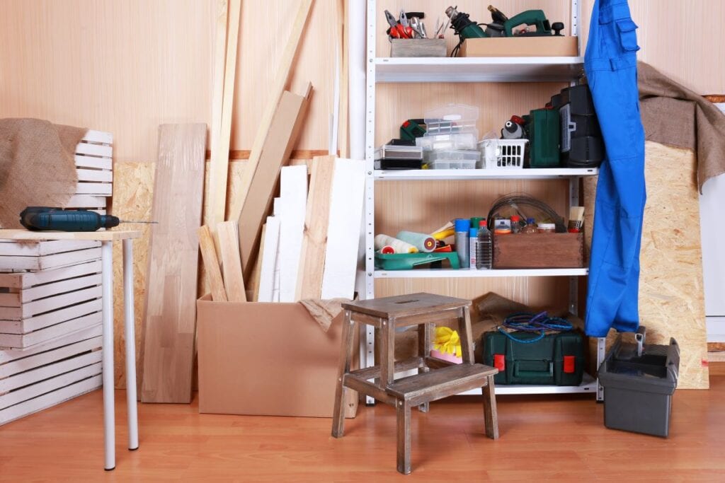 Garage with shelves, boxes, and work bench