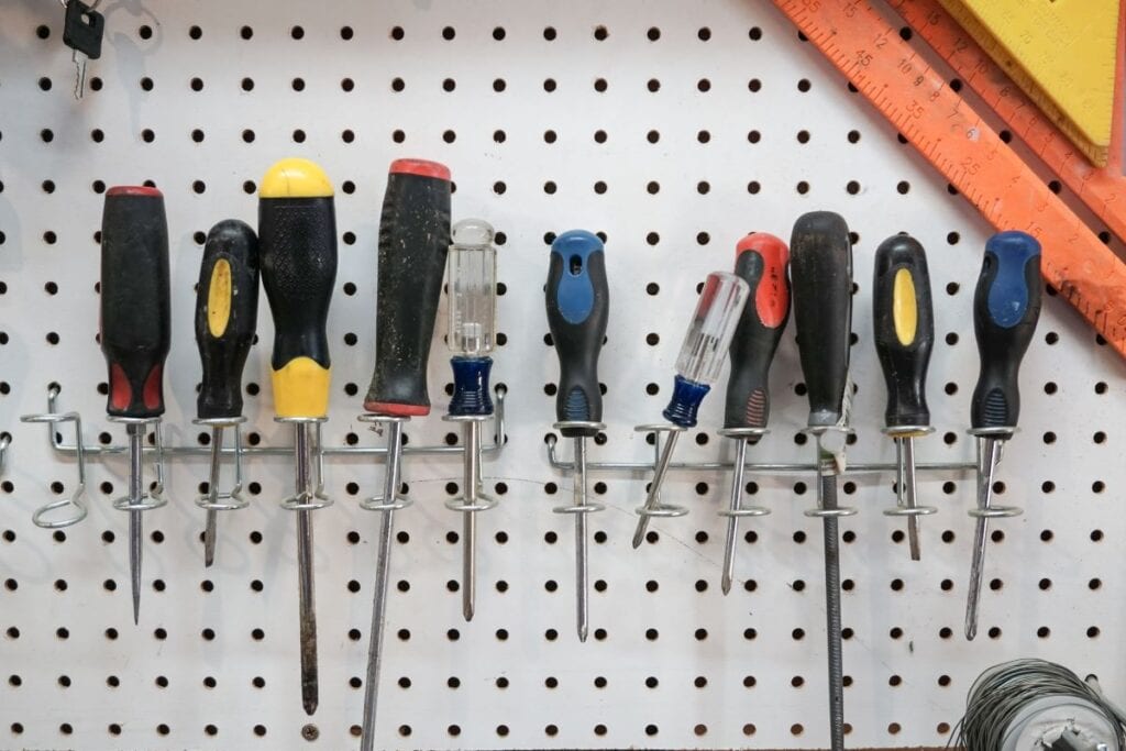 Screwdrivers arranged on pegboard to keep garage organized