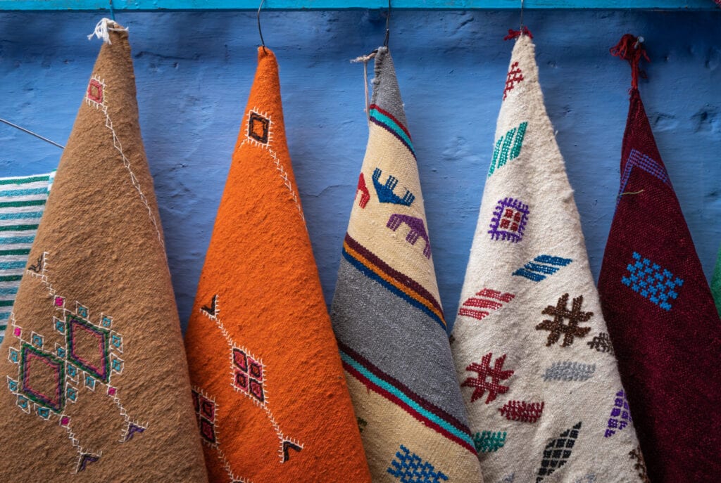 Blue city old walls with carpets in ancient Chefchaouen (or Chaouen), Morocco, North Africa