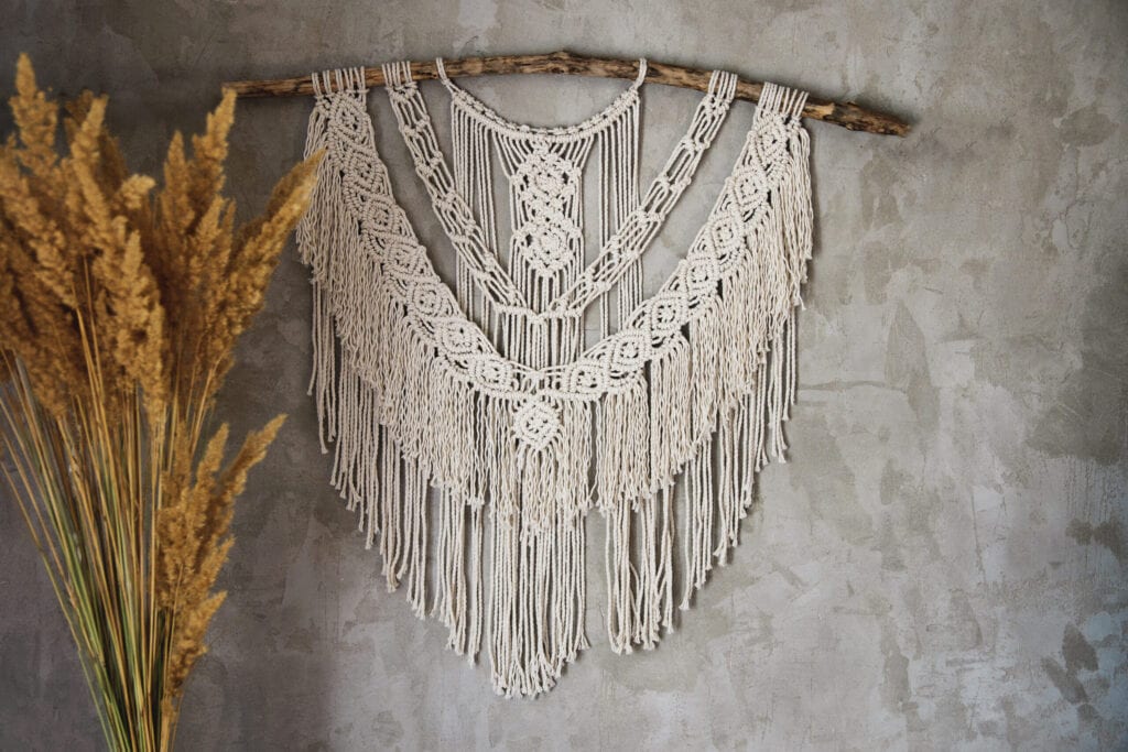 Wall panel in the style of Boho made of cotton threads in natural color using the macrame technique for home decor and wedding decoration. Beautiful boho macrame wall panel will add a cozy atmosphere and charm to any space in your home