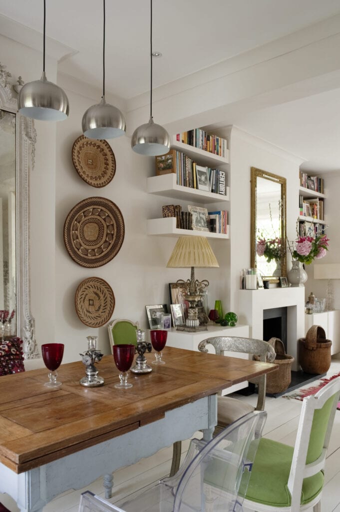 Dinging room with modern silver pendant lights, large french mirror and african coil baskets