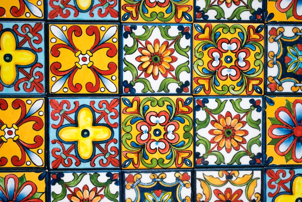Close up of mexican tiled backsplash, with green, yellow, white, red, blue, and white pattern