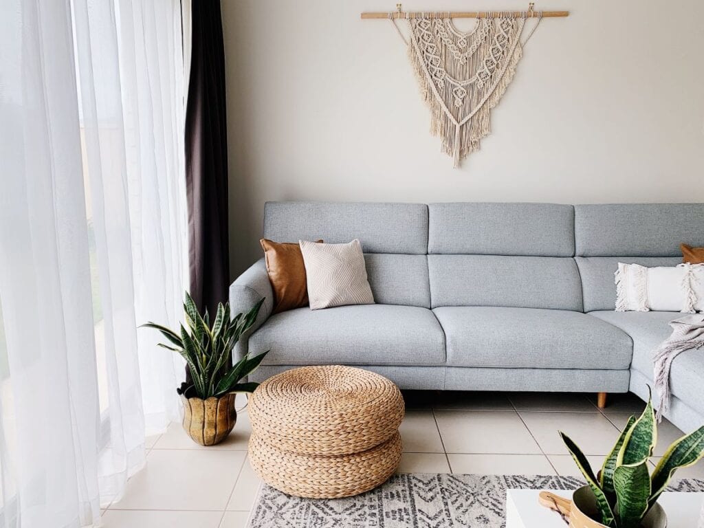 Modern boho chic living room with gray couch and greige wall paint