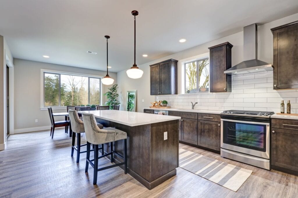 Luxury kitchen with white subway tile backsplash and hardwood floors