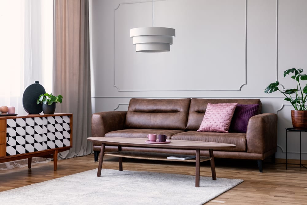 A grey and purple living room styled in mid-century modern decor.