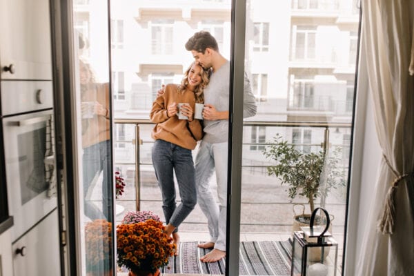 Couple on a balcony with patterned rug