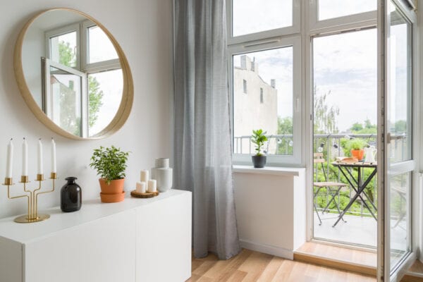 Curtains to window overlooking an apartment balcony