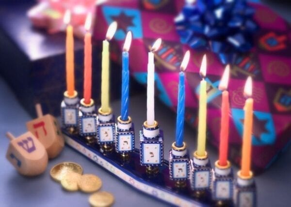 Menorah with dreidels and lit candles