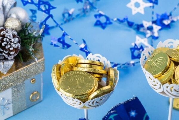 Close up of Hanukkah gelt displayed on decorated tables