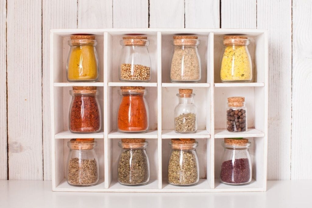 Spices on display in glass jars in kitchen for decor