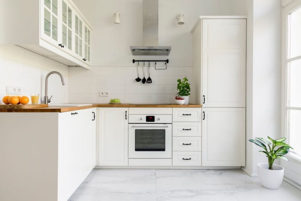 Small apartment kitchen remodeled with white cabinets