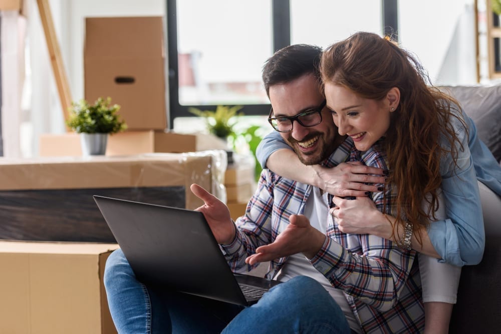 Young couple looks for online bank when they move.