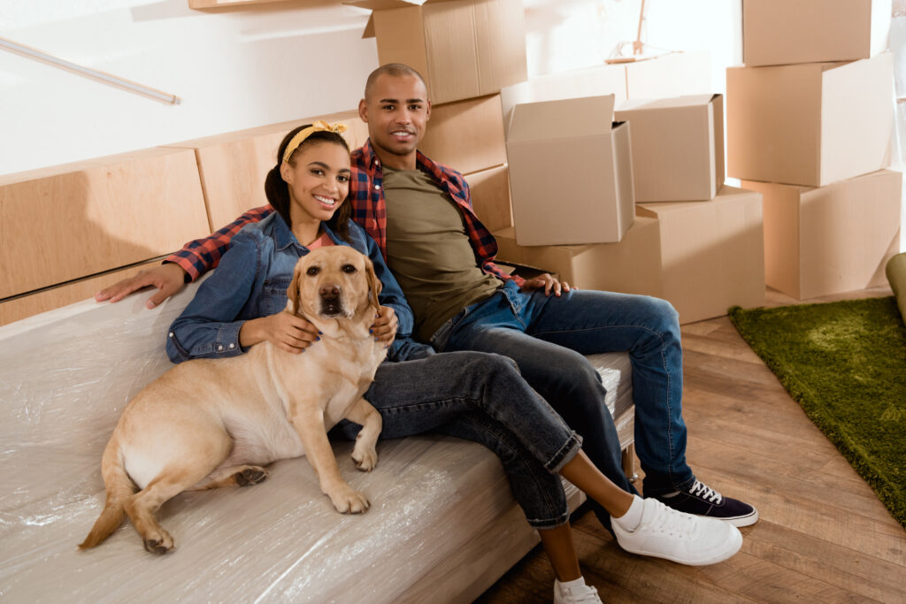 African American couple moving with dog