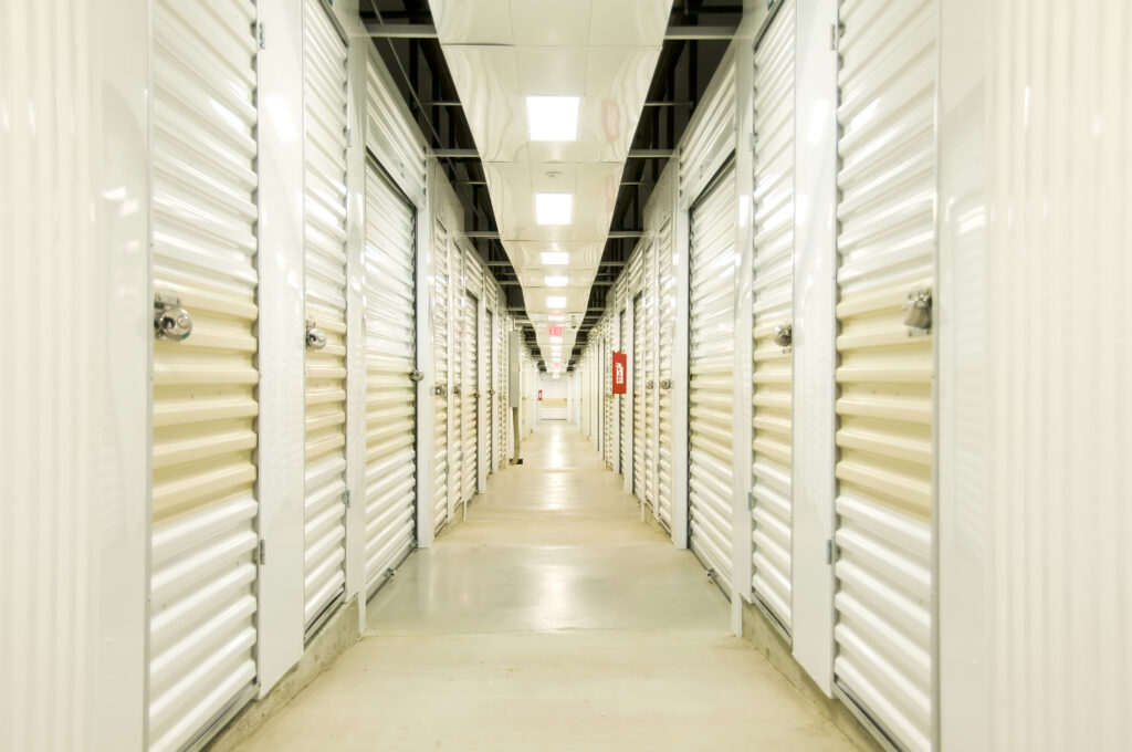 "Self Storage hall with lights, locks, door and concrete floor. Diminishing perspective"