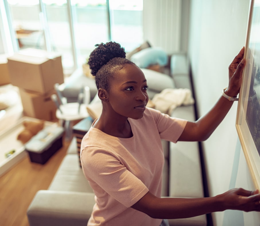 woman hanging picture