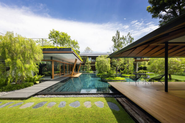 Courtyard pool surrounded by modern wood and glass architecture.