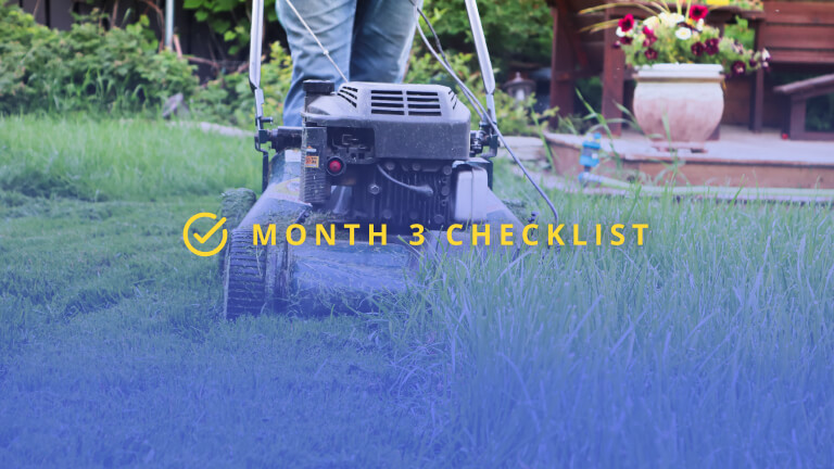 Closeup of a lawnmower cutting tall grass