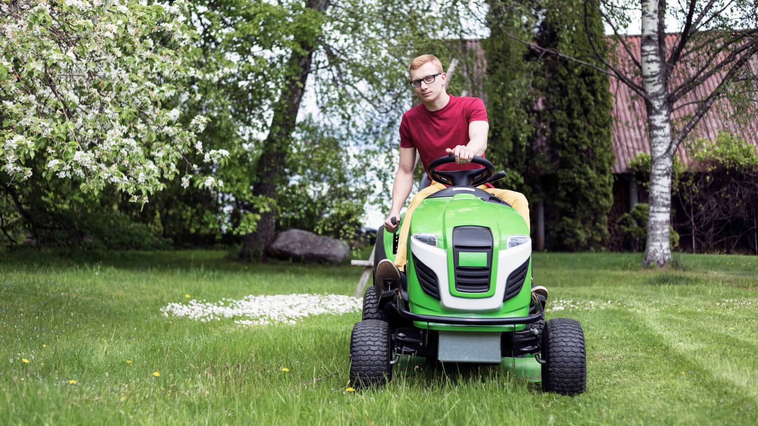 Man steering a riding lawn mower