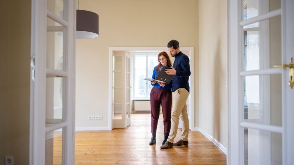 Couple analyzing house documents before buying new house