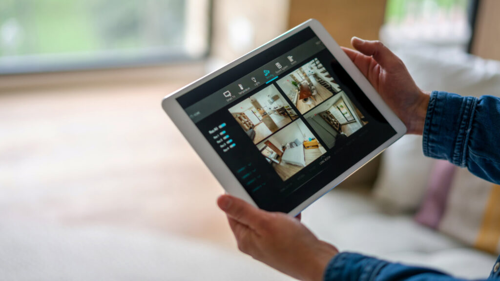 Woman monitoring her house with a home security system