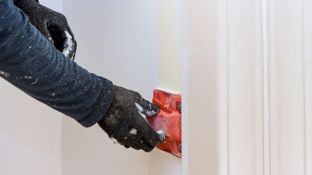 Construction tool for working contractor user in corner paint edger brush painter hands in the painting the wall