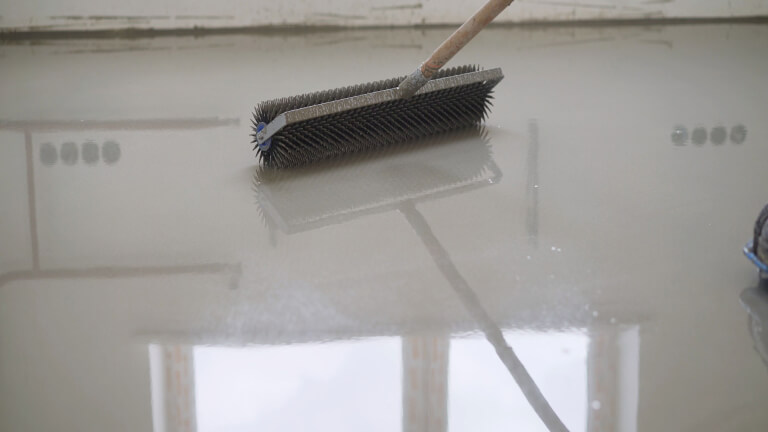 Leveling the floors with a cement mixture.