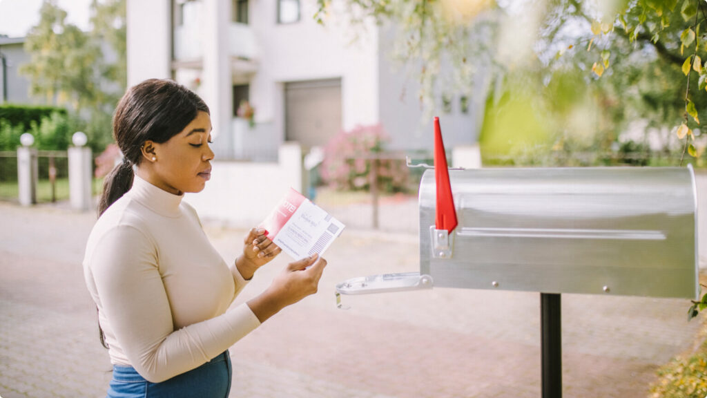 African-American woman receiving voting envelope