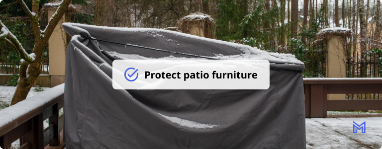 Patio furniture Cover protecting outdoor furniture from snow.